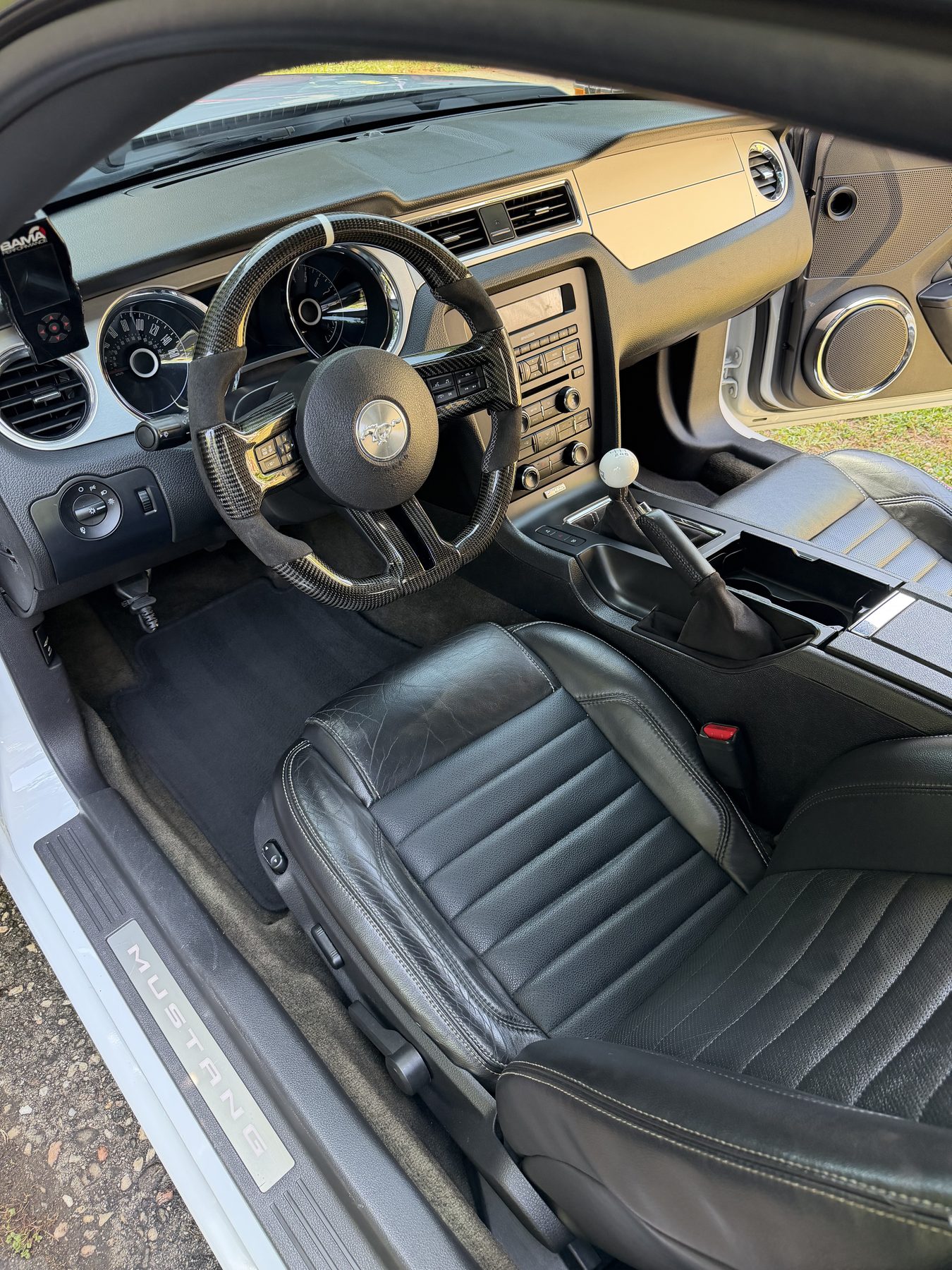Modified Ford Mustang interior detail showing leather and carbon-fiber trim