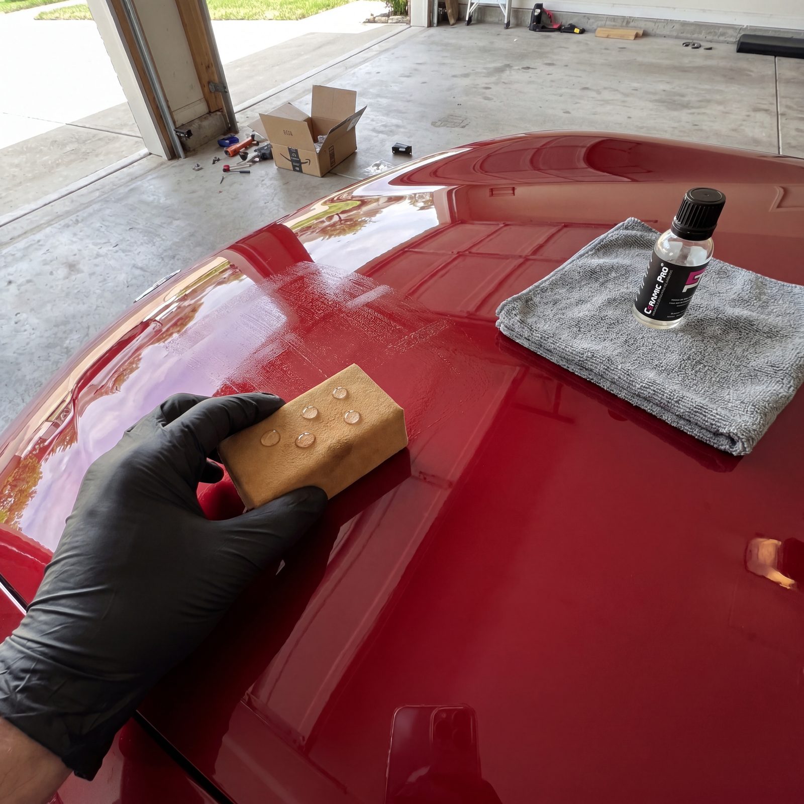 Hand-applying ceramic coating in cross-hatch passes panel by panel